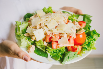 Girl holding healthy salad ready to eat