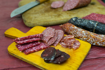 Smoked sausages are cut on a cutting board.