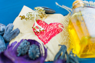 A magical elixir in a bottle. The red heart is painted on paper.