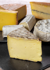 different french cheeses on slate plate