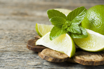 Fresh citrus lime mint berries on wooden background. Copy space for text