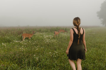 woman with deer in the morning