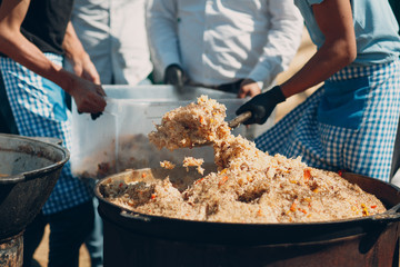 Pilaf with meat in a large cauldron
