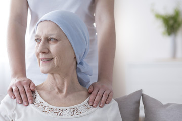 Smiling elderly woman with cancer