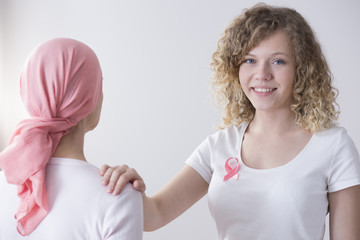 Smiling woman with pink ribbon