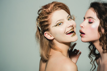 Fashion model shows luxury concept. fashion and beauty concept with two women in gold, copy space