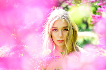 Sakura flower beauty in nature. Sensual woman at blossoming sakura flower in spring. Womens day with girl in pink cherry blossom. Spring woman in cherry flower bloom. Skincare and summer concept