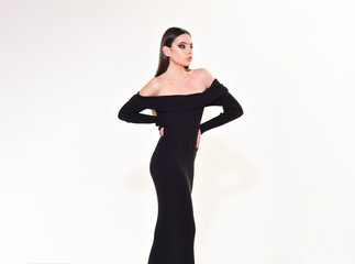 Fashionable woman in dress posing in studio. Fashion photo.