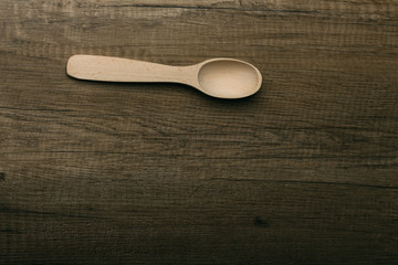 a wooden spoon on a wooden table.