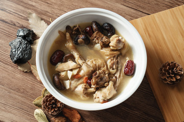 A nutritious chicken soup with a woody background