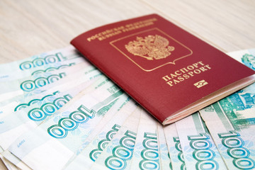 business, finance, saving, banking concept - close up bundle of money Russian Banknotes thousand rubles on wooden table