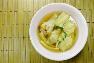 boiled bamboo shoot with chicken leg soup on bowl