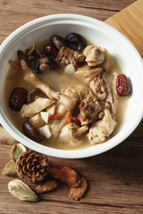 A nutritious chicken soup with a woody background