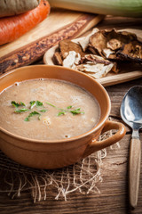 Mushroom soup on a wooden table.
