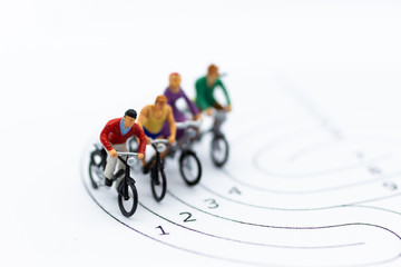 Fototapeta na wymiar Miniature people : Cycling on the track. Image use for Competition of the current society.