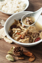 A nutritious chicken soup with a woody background