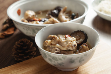 A nutritious chicken soup with a woody background