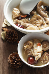 A nutritious chicken soup with a woody background