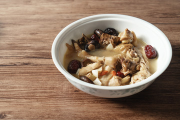 A nutritious chicken soup with a woody background