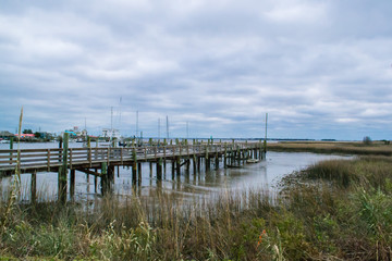 Fototapeta premium Sunset Beach North Carolina - View of the fishing village on a cloudy day