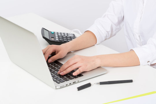 Business young woman typing on laptop computer at office 