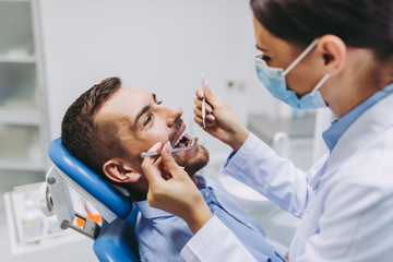 dentist checking patient teeth