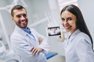 doctor and assistant looking at tablet screen