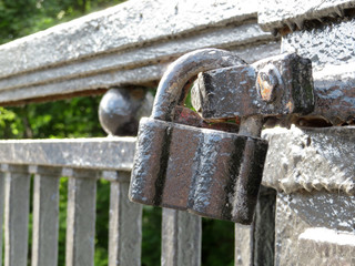 Old padlock on the bridge in summer