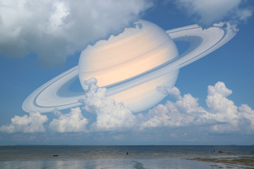 Obraz premium Saturn back cloud sky on sea ,concept Saturn near Earth