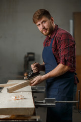 Portrait Male Master carpenter apron in his workshop. Small business