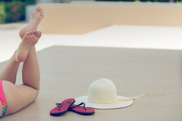 Time to relaxing, Traveller woman lying down beside pool on vacation trip.