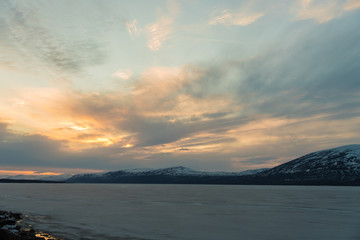The frozen Torneträsk Lake in the Abisko National Park at sunset / Lapland, Sweden