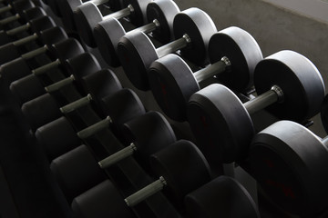 Fototapeta na wymiar Rows of modern dumbbells in the gym , gym equipment concept.