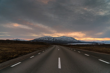 Road in Abisko National Park and Torneträsk Lake at sunset / Lapland, Sweden