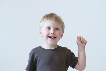 Studio portrait of a cute smiling boy. Happy child.