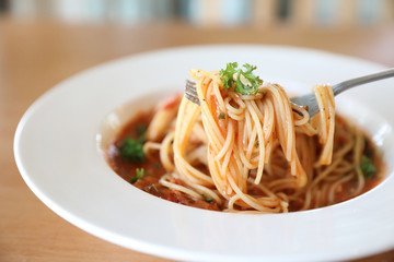 spaghetti Bolognese with minced beef and tomato sauce garnished with parmesan cheese and basil , Italian food