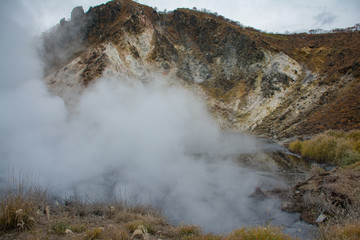 Okunoyu Pond, the smaller hot spring pond near Oyunuma at Noboribetsu Hokkaido, Japan, The word on signboard read Oku no Yu means Okunoyu Pond, backpack traveling concept.