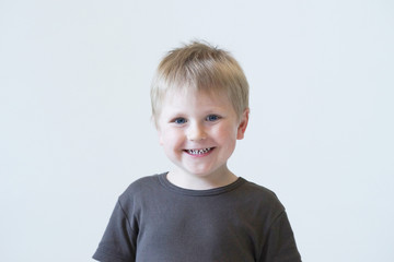 Studio portrait of a cute smiling boy. Happy child.