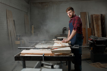 Portrait Male Master carpenter apron in his workshop. Small business