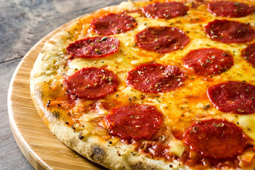 Hot italian pepperoni pizza on wooden table