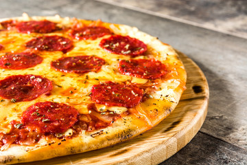 Hot italian pepperoni pizza on wooden table