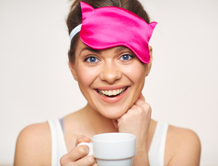 Toothy smiling woman close up portrait with white coffee cup.