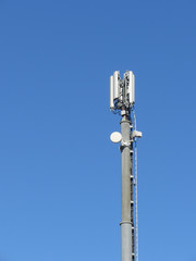 Telephone antenna on blue sky background
