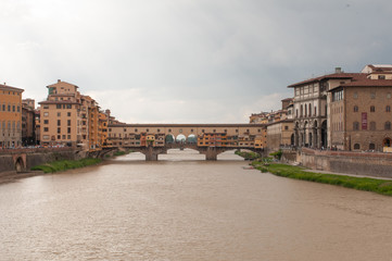 Fototapeta na wymiar View of Ponte Vecchio. Florence, Italy. Old bridge in Florence view to the Arno River. Famous for the goldsmith shops and the Vasari Corridor.