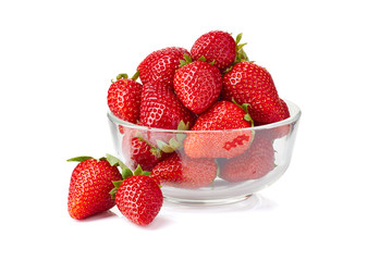 Glass bowl with ripe strawberries on white