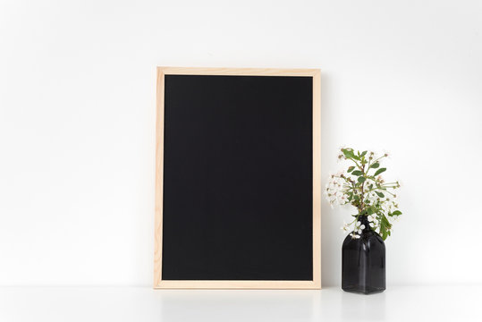 Chalkboard frame mock up with spring cherry bouquet. Mock up for your photo, design or text.