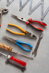 Set of different construction vintage tools and instruments for household on gray concrete background