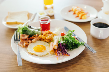 Fresh breakfast table in the hotel. Egg,.sausage,salad,ham,bread and dessert.