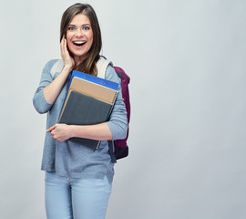 Obraz premium Smiling student woman with backpack holding books, notebooks.