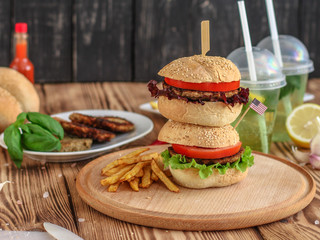 burgers on a slate plate and frothy beverage  - fast food (sandwich) - cuisine.  Food background